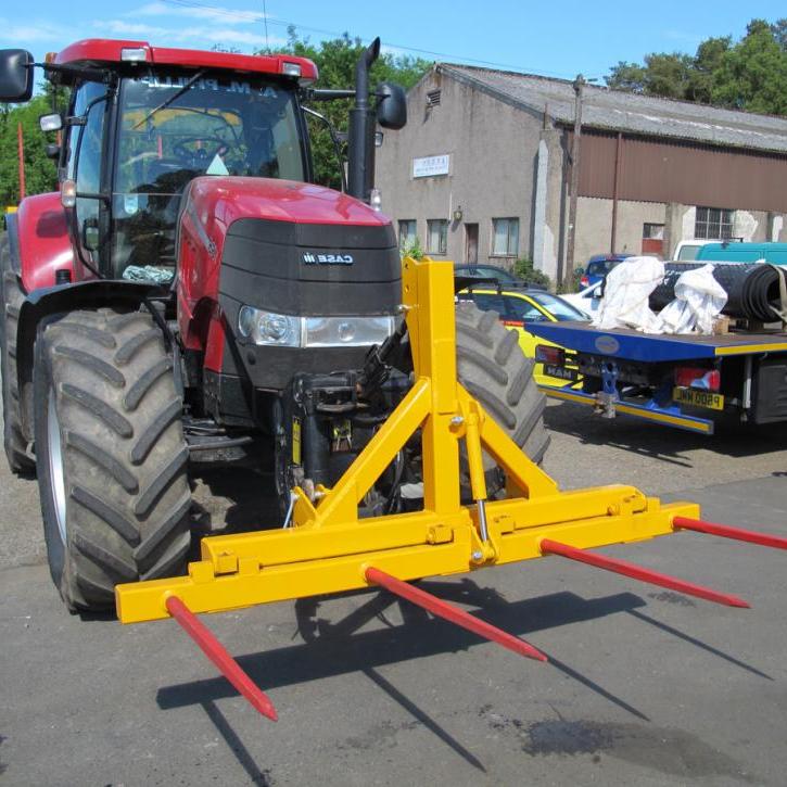 Hydraulically folding Front or Rear Bale Spike on the front linkage of a tractor.